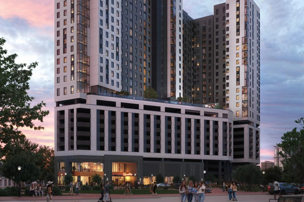 Modern high-rise residential building with a ground-level plaza and groups of people gathering outside at dusk.